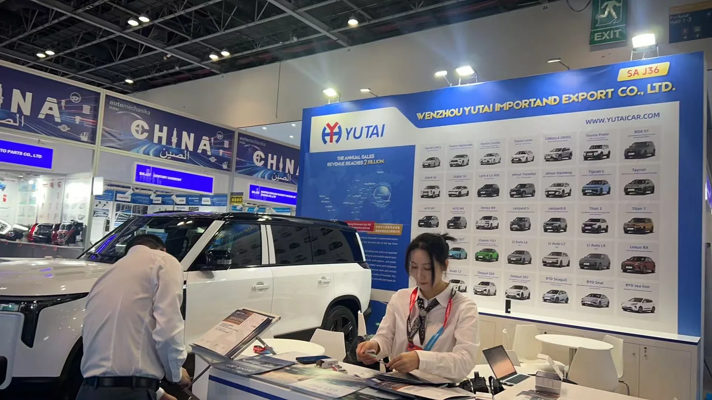 Yutai team discussing vehicles with visitors at the Yutai exhibition stand